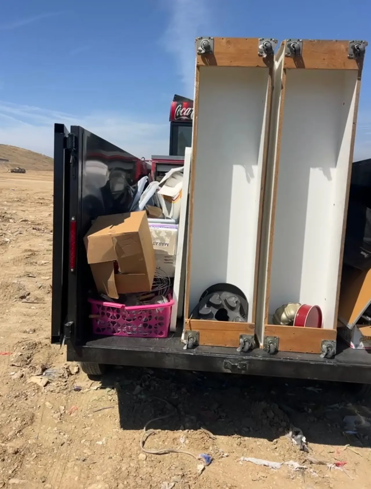 Trailer packed with cabinets, boxes and household items at the drop-off site